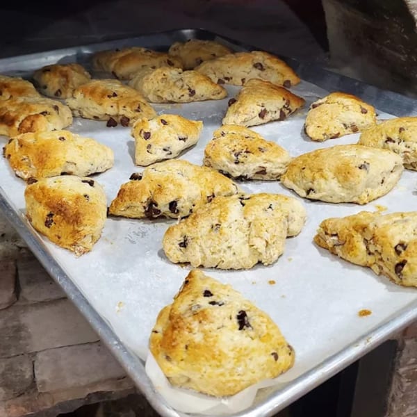Freshly baked chocolate chip scones on a baking sheet, ready to be served at The Woodstock Way Groovey Eatery.